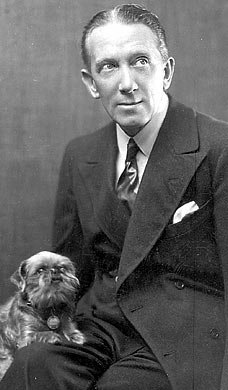 Gerald du Maurier, seated with a dog Gerald du Maurier, seated with a dog