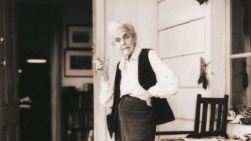 Nora Heysen with her dog standing outside her home, Hunters Hill, Sydney