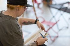 A woman with a pencil and drawing pad