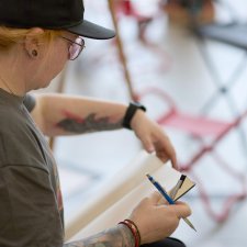 A woman with a pencil and drawing pad