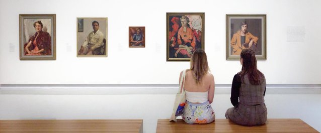 Visitors in Gallery One, March 2026, featuring works by Sir Ivor Hele, Ernest Buckmaster, Nancy Borlase AM, Clifton Pugh AO and Graeme Inson © Estate of Ivor Hele, Estate of Ernest Buckmaster, Estate of Nancy Borlase, Shane Pugh, Harvey Shore