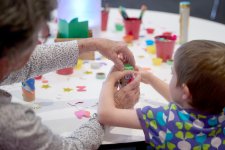 Grandparents and children at a table with craft activities