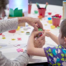 Grandparents and children at a table with craft activities