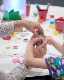 Grandparents and children at a table with craft activities