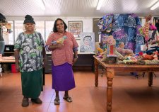 Dulcie Sharpe and Rhonda Sharpe in a room with a brown tile floor, next to a wooden table with soft animal sculptures Dulcie Sharpe and Rhonda Sharpe in a room with a brown tile floor, next to a wooden table with soft animal sculptures