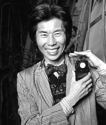 William Yang with light
meter at John Fink's
21st birthday, late 80s William Yang