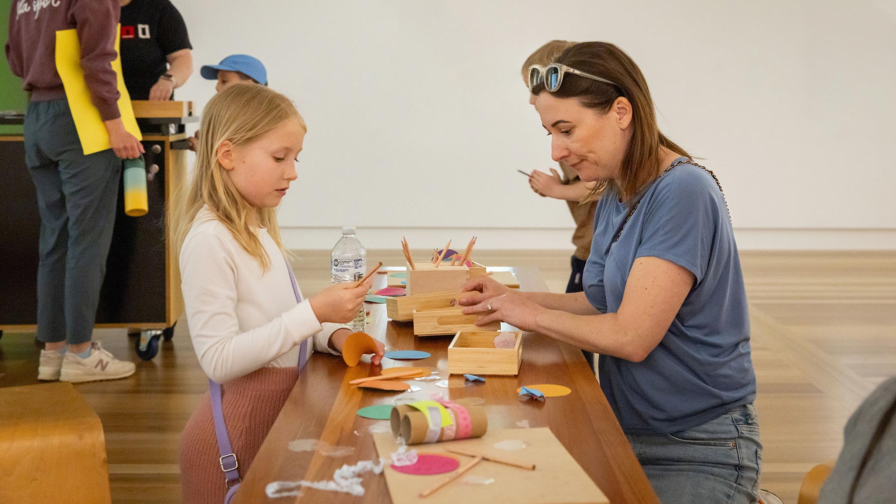 Parents and children at a table with craft activities